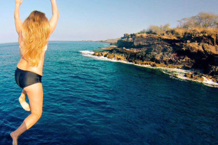 a person standing next to a body of water