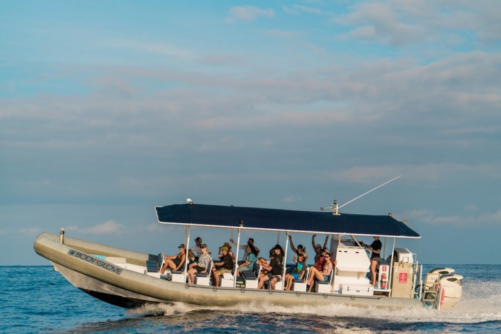 a group of people in a boat on a body of water