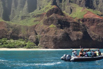 a small boat in a body of water with a mountain in the background