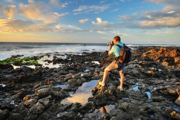 a man standing on a rocky beach