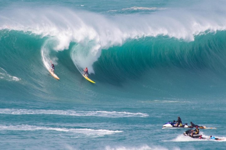 a man riding a wave on a surfboard in the ocean
