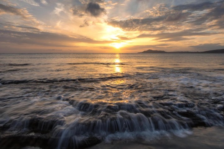 a sunset over a body of water