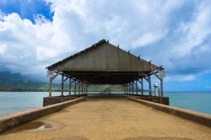 a close up of a pier next to a body of water