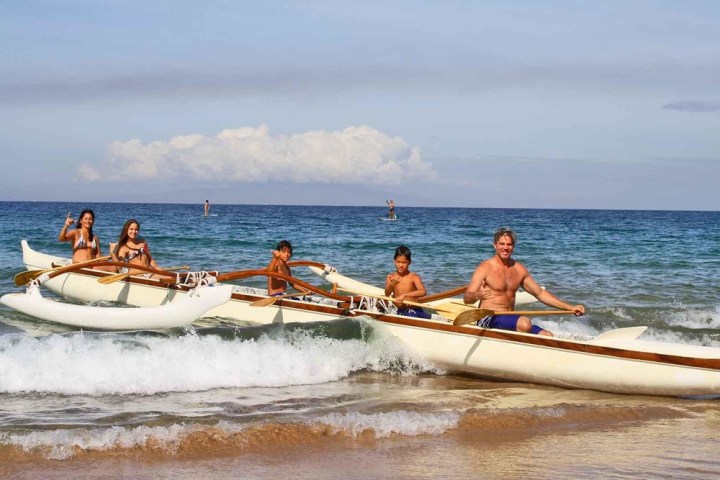 a group of people in a boat on a body of water