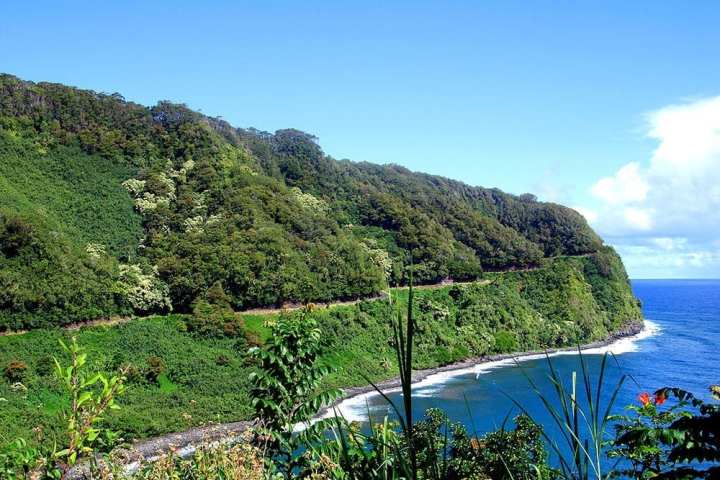 a body of water with Hana Highway in the background