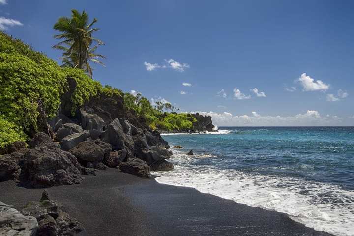 a rocky beach next to a body of water