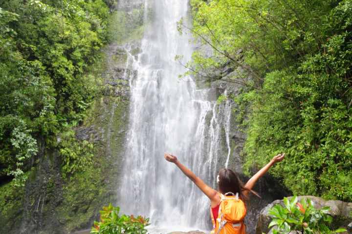 a person standing next to a waterfall