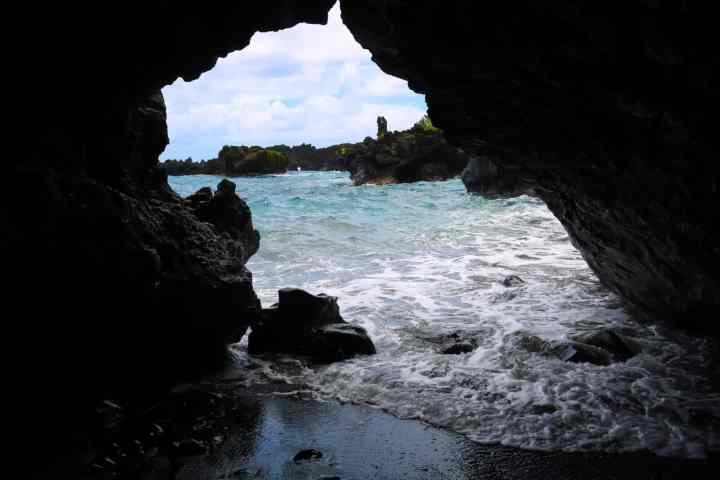 a cave next to a body of water