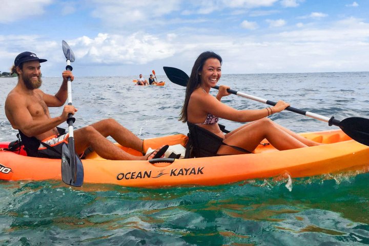 Jessica Blackmun et al. riding on the back of a boat in the water