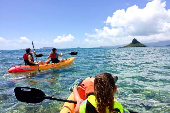a group of people in a boat on a body of water