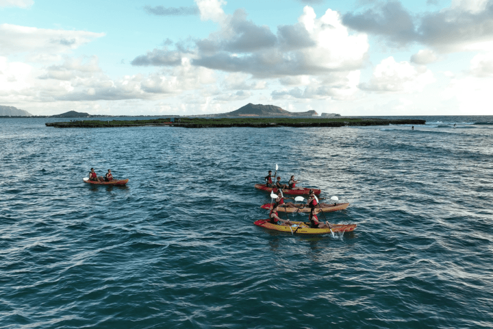 a group of people in a small boat in a body of water