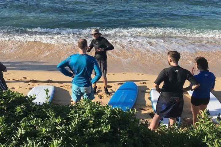 a group of people sitting at a beach
