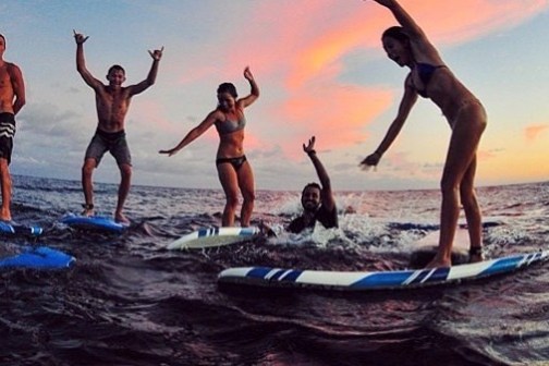 a group of people surfing