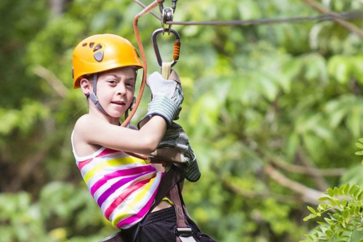 a young girl ziplining