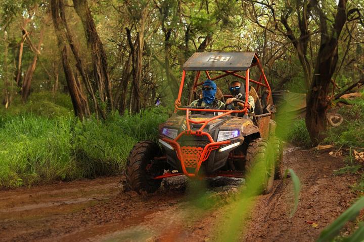 a atv driving down a dirt road