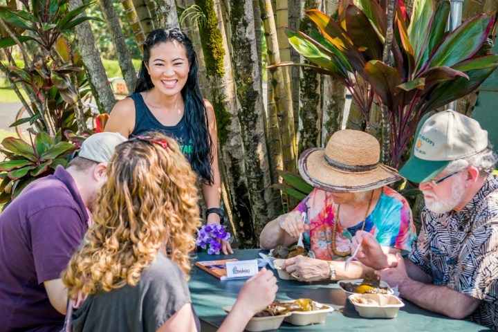 a woman sitting at a table with food