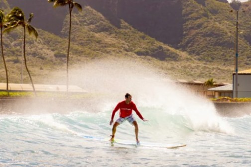 a man riding a wave on top of a mountain