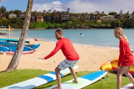 a group of people standing next to a body of water