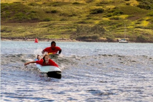 a man riding on the back of a boat in a body of water