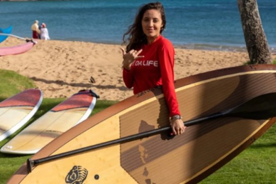a person carrying a surf board on a beach