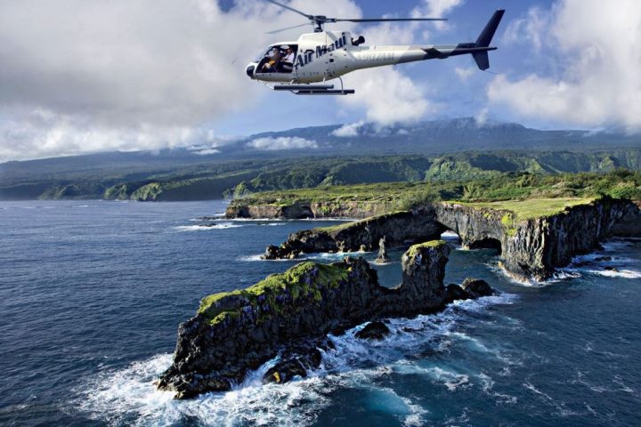 a helicopter flying over a body of water