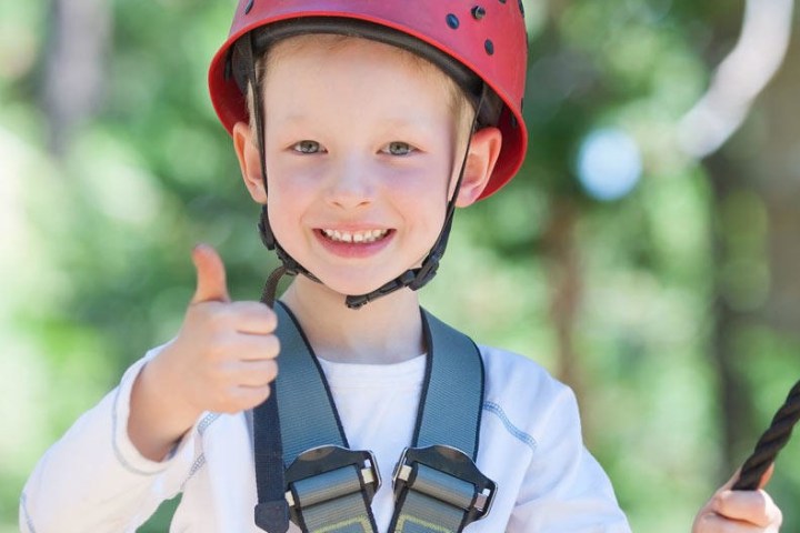 a little boy wearing a helmet holding a baseball bat