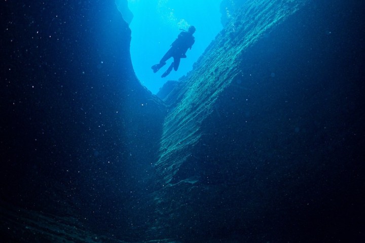 a person diving in sea caves