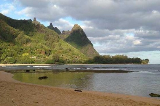 a body of water with a mountain in the background