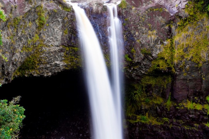 a large waterfall over some water