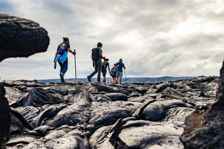 a man standing on a rocky lava