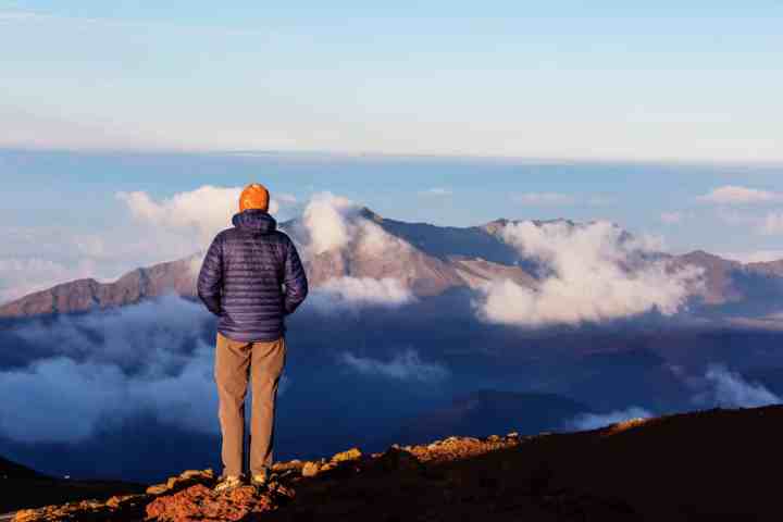 a man standing on top of a snow covered mountain