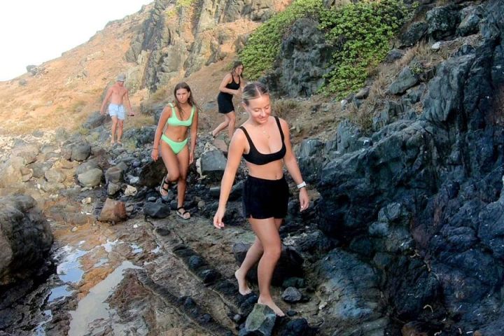 a woman hiking in a rocky area