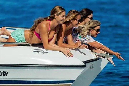 a woman standing next to a body of water